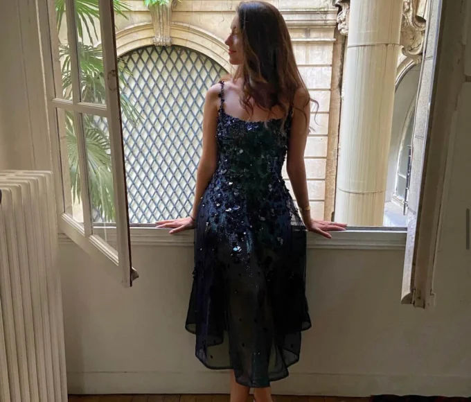 Elegant-woman-standing-in-a-window-frame